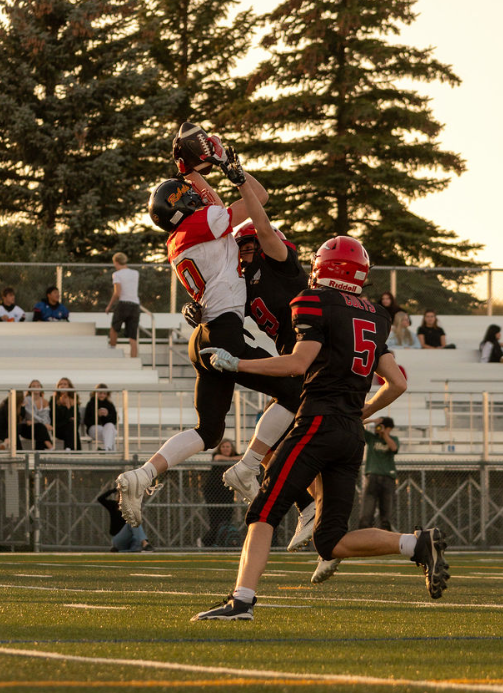 Rebels player reaching up for a pass