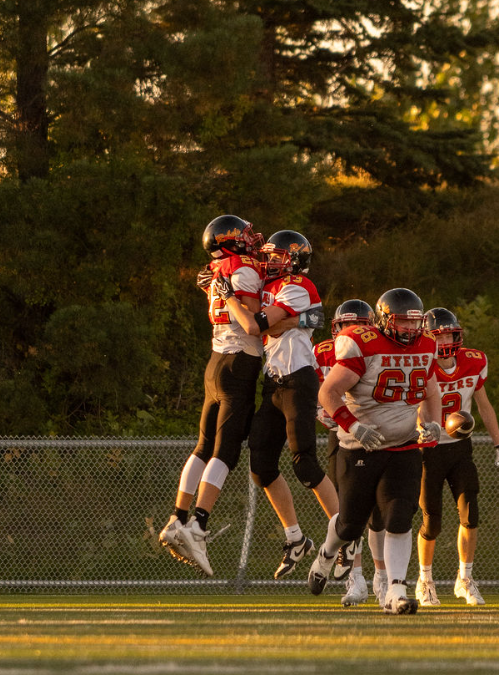 Rebels players celebrating on the field